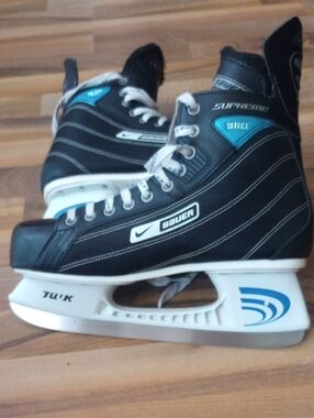 Bauer Black Hockey Skates with Teal Accents
